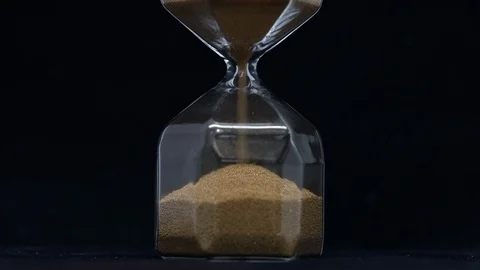 Close-Up on Sand Flowing Through an Hour Glass Stock Footage 127981664