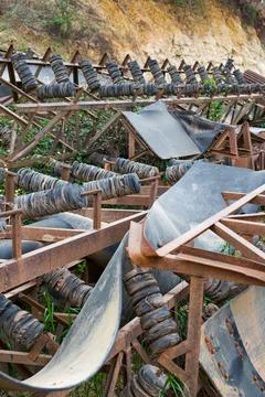 Close-up of sand mining equipment by the river beach Fotos de archivo