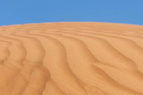 Close up of sand patterns and blue sky background showing textures and shapes Stock Photos
