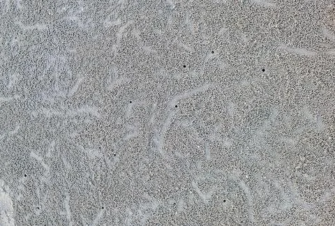 Close up to sand patterns and small sand pellets created by crab on beach. .. Stock Photos