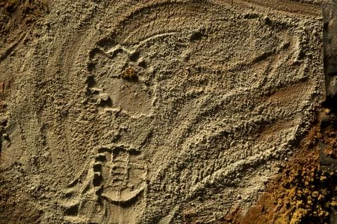 Close-up of a sand surface showing patterns and marks left by construction to Stock Photos