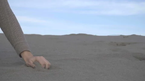 Close up of sand through your fingers. Female hand taking up the sand Stock Footage 89783812