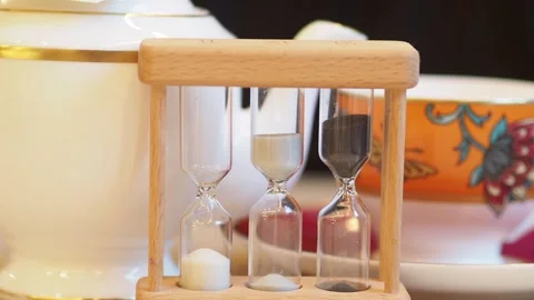 Close Up Of A Sand Timer In Front Of A Tea Cup And tea Pot, London, UK Stock Footage 302089632