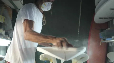 Close up sanding the bottom of a surfboard being shaped Stock Footage 64410517