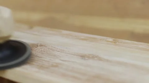 Close-up of a sandpaper, a sander that polishes the surface of a wooden table Stock Footage 256548069