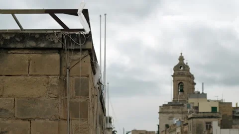 Close-Up of Sandstone Building Corner with Blurred Ancient Cathedral Background Stock Footage 330827658