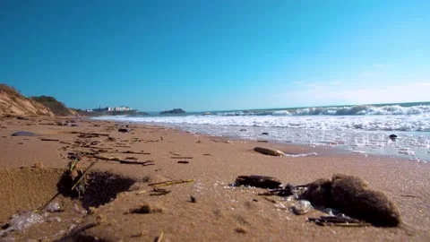 Close up of sandy beach with ocean waves coming inland. south wales tenby uk Stock Footage 152097121