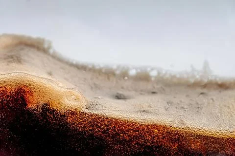 Close-up of sandy beach with small dunes and soft waves Stock Photos