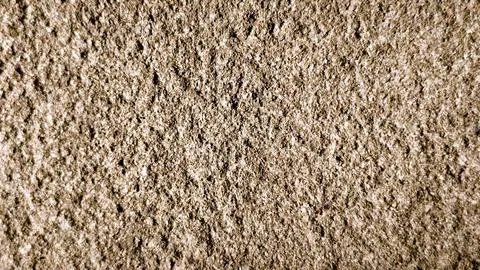 A close up of a sandy surface with a lot of small holes Stock Photos