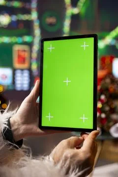 Close up of Santa Claus using mockup tablet in North Pole workshop Stock Photos