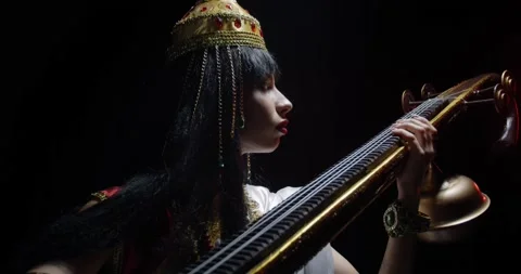Close up of Saraswati with golden crown, while playing veena, traditional, 4k Stock Footage 135375912