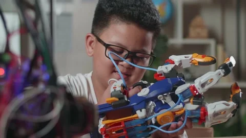 Close Up Of Satisfied Asian Cute Boy Looking And Checking A Cyborg Hand Stock Footage 212018686