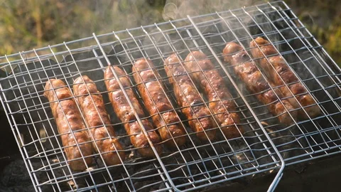 Close up of sauages on a small bbq grill Stock Footage 115055702