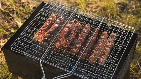 Close up of sauages on a small bbq grill Stock Footage 115055974