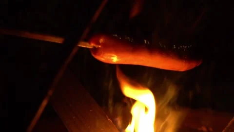 Close up of a sausage on fire Видео 136423163