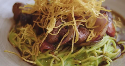 Close-Up of Sautéed Loin with Pesto Spaghetti – High-Definition Culinary Footage Stock Footage 291103353