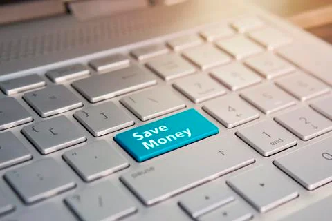 Close up of Save money keyboard button. Color button on the gray silver keybo Fotos de archivo