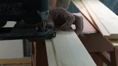 Close-up sawing jigsaw in the board, the process of cutting the board Stock Footage 113602444