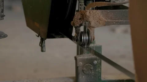 A close-up of a sawmill machine component, showing a metal blade Stockbeeldmateriaal 295413021