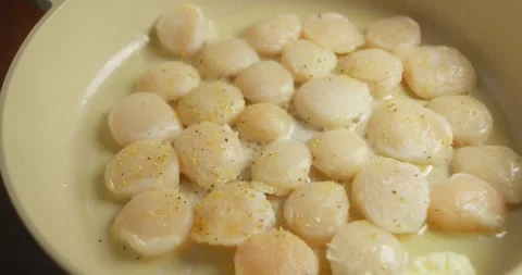 Close-up of scallops being turned to achieve an even golden sear, homemade Vídeos de archivo 327967042