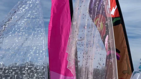 Close scan of pink and translucent banners waving in wind Video stock 233029857