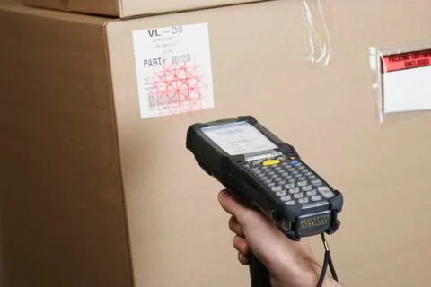 Close up of scanner gun scanning package Photos