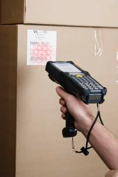 Close up of scanner gun scanning package Photos