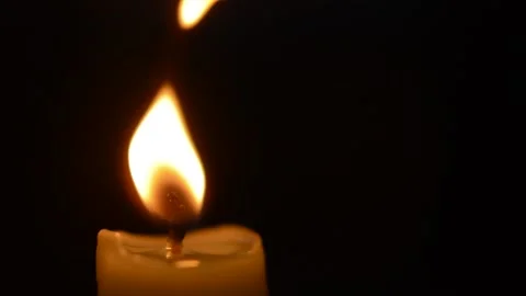 Close-up scary horror glowing red fire of a candle during halloween night. 스톡 동영상 211337375