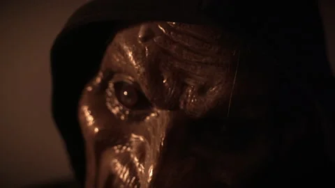 Close up of scary spooky monster puts on protective medical mask on the face.  Stock Footage 141227514
