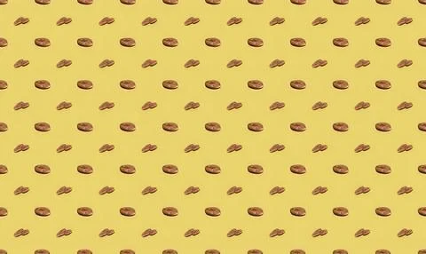 Close-up of scattered chocolate chips on yellow background Stock Illustration