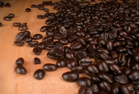 Close-up of scattered coffee beans, camera dollies right Video stock 86883777