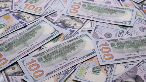 Close-Up of Scattered One Hundred Dollar Bills in Slow Motion Stock Footage 339094620
