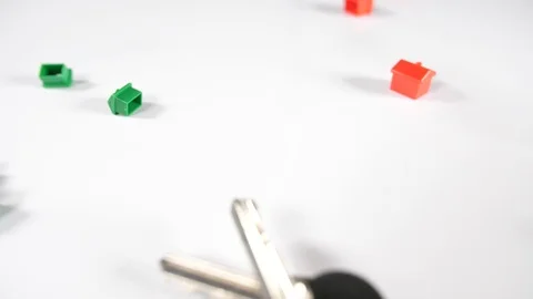 Close up of scattered red and green game house playing pieces and door keys Stock Footage 89191317