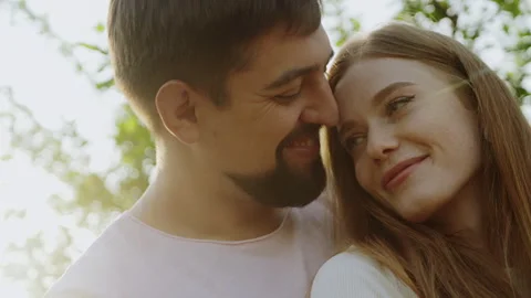 Close up scene of a beautiful young couple embracing and smiling in nature Stock Footage 245181639
