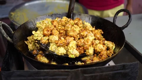 A close-up scene of frying crispy tikadi called flitter and pakoda Indian s.. 스톡 동영상 249755027