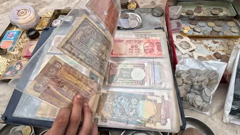 Close-up scene of a man displaying old and vintage collectible currency notes Stock Footage 247402105