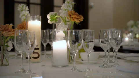 Close up scene of served table with glasses, plates, cutlery and candles at the Stock Footage 304469420