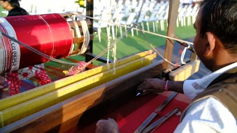 Close-up scene in which a Patola saree craftsman artist with his hands Stock Footage 243888919