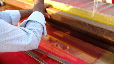 Close-up scene in which a Patola silk saree craftsman is working by hand Stock Footage 243888876