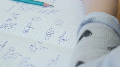 Close up of school girl solves math in her notebook, 4k shot Stock Footage 62530288