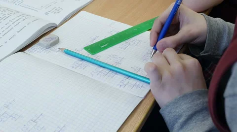 Close up of schoolboy solves math in his copybook at elementary school, 4k shot Stock Footage 62531141