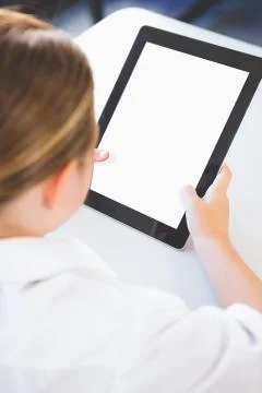 Close-up of schoolkid using digital tablet in classroom at school 스톡 사진