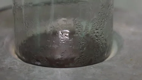 Close-up of a Scientific Glass Beaker Heating on a Laboratory Hot Plate Stock Footage 339651168