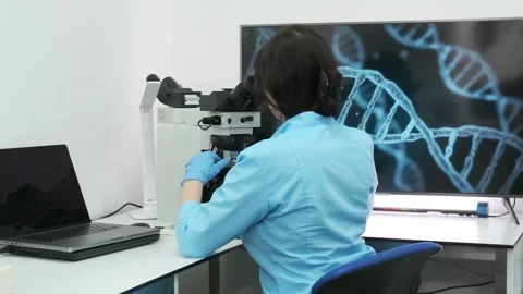 Close-up of a scientist examining samples under a microscope Видео 269302056