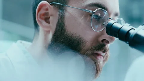 Close Up of Scientist Examining Specimen through Microscope Lens 스톡 동영상 331337766