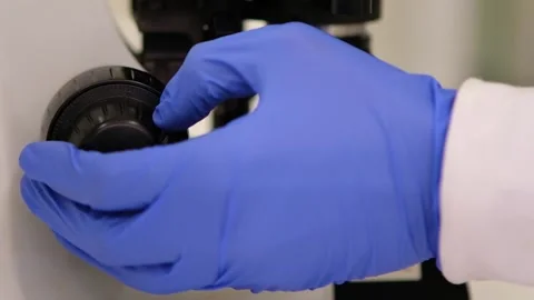 Close-up of scientist hands using microscope Stock Footage 133375128