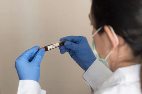 Close up of scientist looking at plants in test tube in laboratory, Concept s Stock Photos