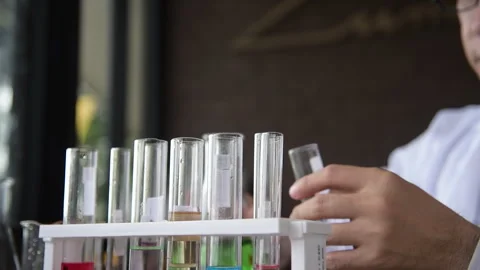 Close up Scientist man hands holding sample blood test tube science laboratory.  Stock Footage 249139828