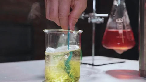 Close-up of scientist mixing chemical solution for experiment at laboratory Stock Footage 97564662