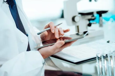 Close-up. scientist reading notes in his digital tablet. Stock Photos